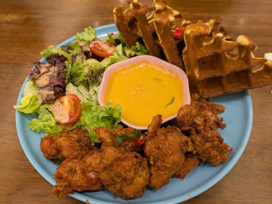 Boneless fried chicken with waffles, salad and salted egg sauce